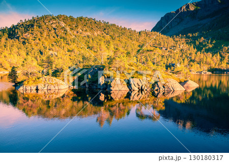 Rocky bank of a mountain lake in autumn. Beautiful autumn nature of Norway. Lake with reflection Rocky bank of a mountain lake in autumn. Beautiful autumn nature of Norway. Lake with reflection 130180317