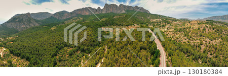 Panoramic view from above of the valley and the mountain ridge during sunrise. Coves del Canelobre near Busot, Alicante, Spain 130180384