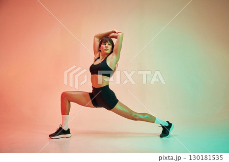 Yoga asana, for legs. Young woman in fitness clothes is in the studio Yoga asana, for legs. Young woman in fitness clothes is in the studio 130181535