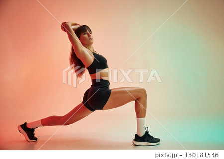 Yoga asana, for legs. Young woman in fitness clothes is in the studio 130181536