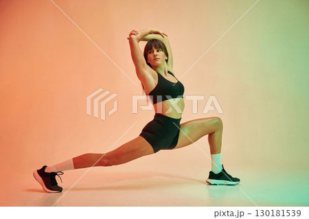 Yoga asana, for legs. Young woman in fitness clothes is in the studio 130181539