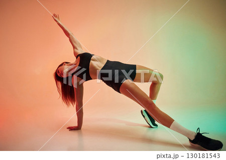 Physical activity. Young woman in fitness clothes is in the studio 130181543