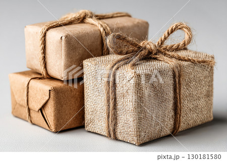 Classic gift. Minimalist brown Kraft Gift Box with twine bow on white background. 130181580