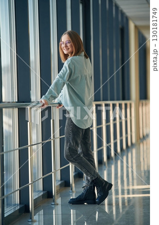 Front view. Young woman in airport hall 130181749