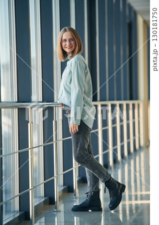 Front view. Young woman in airport hall 130181750