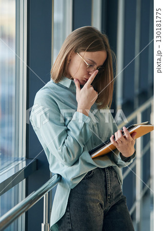 Reading the information from tablet. Young woman in airport hall 130181775