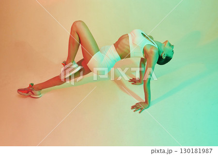 Professional yoga practitioner. Young fitness woman in sportive clothes against background in studio 130181987