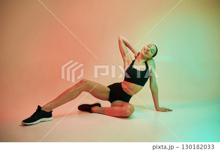Skinny body shape. Young fitness woman in sportive clothes against background in studio Skinny body shape. Young fitness woman in sportive clothes against background in studio 130182033