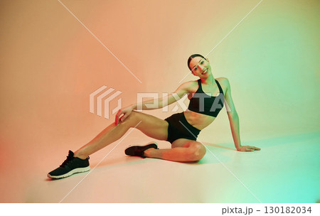Skinny body shape. Young fitness woman in sportive clothes against background in studio Skinny body shape. Young fitness woman in sportive clothes against background in studio 130182034