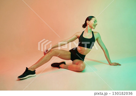 Skinny body shape. Young fitness woman in sportive clothes against background in studio Skinny body shape. Young fitness woman in sportive clothes against background in studio 130182036