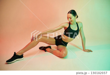 Skinny body shape. Young fitness woman in sportive clothes against background in studio Skinny body shape. Young fitness woman in sportive clothes against background in studio 130182037