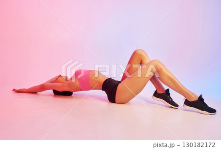 Side view. Young fitness woman in sportive clothes against background in studio Side view. Young fitness woman in sportive clothes against background in studio 130182172