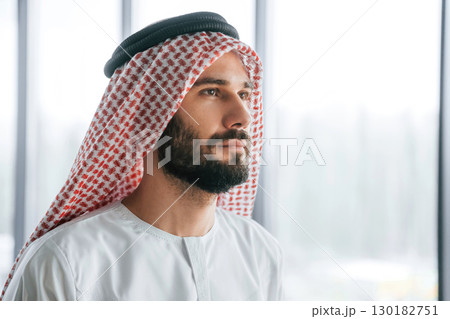 Profile portrait. Successful Muslim businessman in traditional outfit in his office 130182751