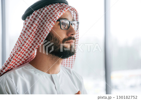 Profile portrait. Successful Muslim businessman in traditional outfit in his office 130182752