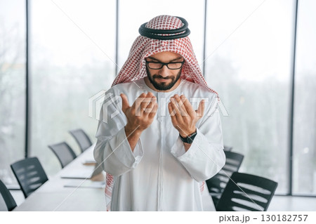 Conception of rich person. Successful Muslim businessman in traditional outfit in his office 130182757