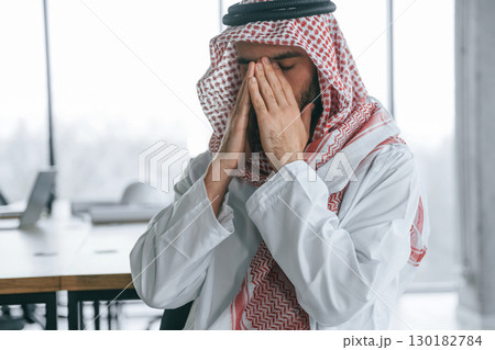 Successful Muslim businessman in traditional outfit in his office 130182784