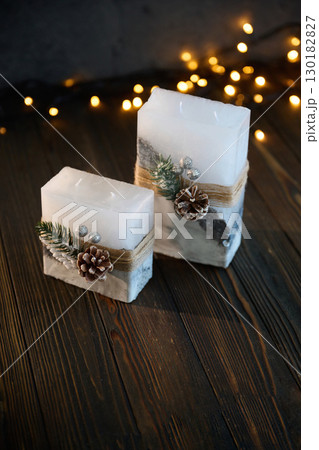 Wooden surface. Handmade beautiful decorative candle on the background 130182827