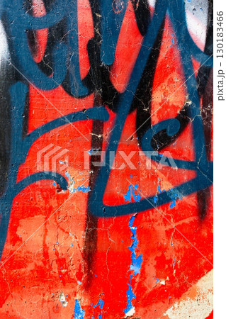 Vibrant Graffiti Art with Bold Black Blue Spray on Red Grunge Wall Vibrant Graffiti Art with Bold Black Blue Spray on Red Grunge Wall 130183466
