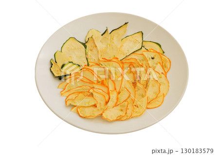 Survival food. Food prep Dried zucchini on a ceramic plate isolated on a white background. Various dry of zucchini. 130183579