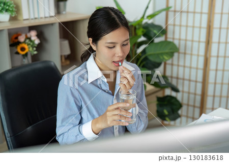 Office Syndrome Woman Drinking Water While Taking Medication 130183618