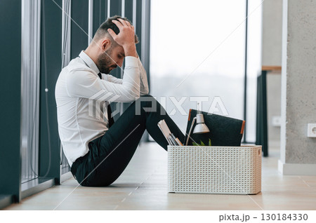 Unemployed man is with personal belongings after being fired Unemployed man is with personal belongings after being fired 130184330