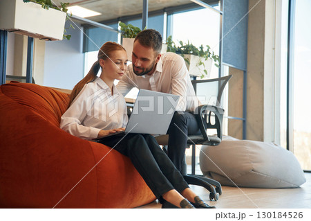 Affectionate lovely look. Man and woman employees are working in the office Affectionate lovely look. Man and woman employees are working in the office 130184526