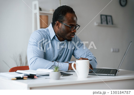 Manager is using laptop. Businessman is working in the office 130184787