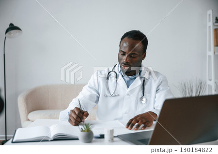 Black man as doctor in the clinic office 130184822
