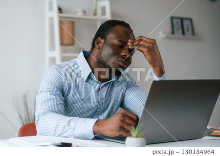 Feeling bad, stressful. Businessman is working in the office by laptop 130184964