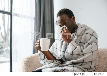 Terrible flu. Sick black man is at home 130184983