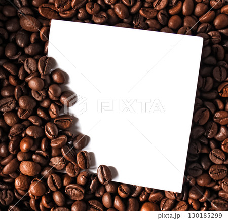Against the backdrop of coffee beans is a business card 130185299