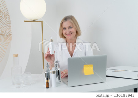 A Professional Woman Surrounded by Skincare Products Inside a Contemporary Modern Workspace 130185943