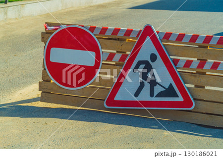 Restrictive road signs indicating Passage prohibited are colloquially called brick and a warning triangular sign Road Construction Works . Traffic and direction control 130186021