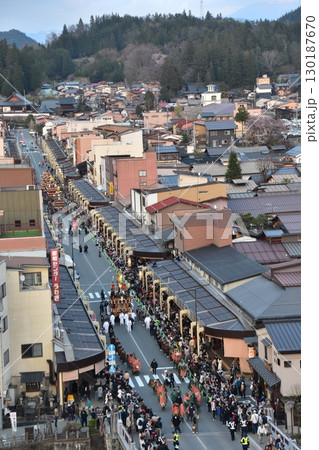 日本の岐阜県の高山市　春の高山祭の夜祭　日没後に巡行する提灯屋台　周辺の街並みと商店街と群衆の様子 130187670
