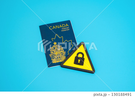 Canadian citizen passport and symbol of restriction. Restrictions on rights and freedoms to leave the country. Barriers to obtaining Canadian citizenship, travel bans, immigration policy, visas 130188491
