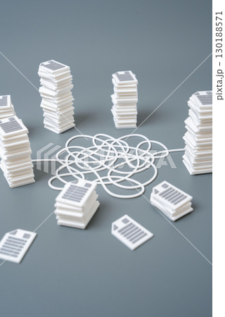 A tangled line in a circle of stacks of papers and documents. Bureaucratic hell, paperwork overload, delays, inefficiency, workflow optimization, solving formalities 130188571