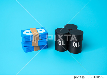 Money and oil barrels. Payment for energy resources, crude oil trade, export revenue, oil sales profit, fuel market, energy business, global commodity transactions Money and oil barrels. Payment for energy resources, crude oil trade, export revenue, oil sales profit, fuel market, energy business, global commodity transactions 130188582