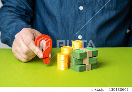 Question mark near a stack of money. Where to invest and how to protect savings from inflation, financial planning, safe assets, personal wealth strategy. 130188601