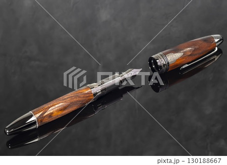 Fountain pen on dark marble background. Rare writing instruments. Fountain pen on dark marble background. Rare writing instruments. 130188667