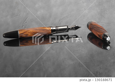 Fountain pen on dark marble background. Rare writing instruments. 130188671