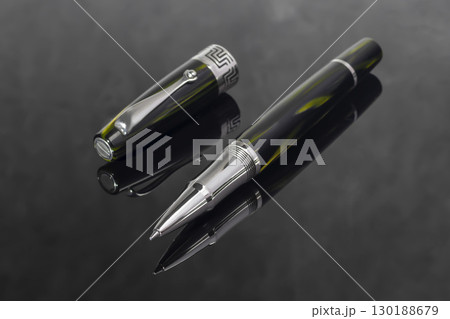 Fountain pen on dark marble background. Rare writing instruments. 130188679