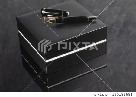 Fountain pen on dark marble background. Rare writing instruments. Fountain pen on dark marble background. Rare writing instruments. 130188681