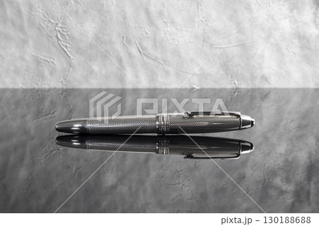 Fountain pen on dark marble background. Rare writing instruments. Fountain pen on dark marble background. Rare writing instruments. 130188688