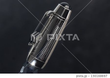 Fountain pen on dark marble background. Rare writing instruments. Fountain pen on dark marble background. Rare writing instruments. 130188697