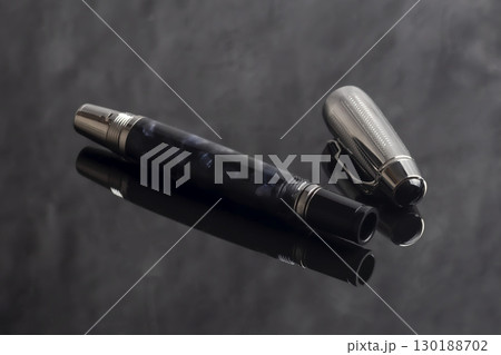 Fountain pen on dark marble background. Rare writing instruments. 130188702