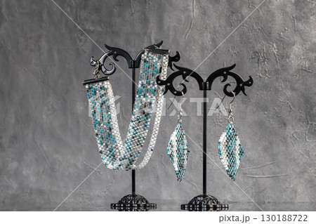 Bracelet and earrings made of beads on a light background. Handmade. Jewelry 130188722