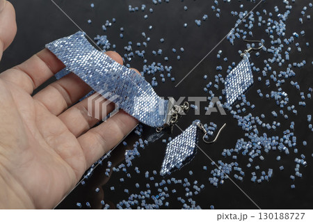Bracelet and earrings made of beads on a light background. Handmade. Jewelry 130188727