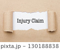 Injury Claim text appearing behind brown paper 130188838