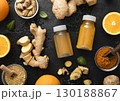 Bottles of immune ginger and orange energy shot drink with ginger root and turmeric powder.Top view. 130188867
