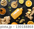 Immune ginger and orange energy shot drink with ginger root and turmeric powder on black. 130188868